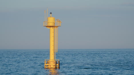 Yellow-Buoy-In-The-Ocean-During-Daytime