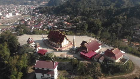Orbit-shot-of-buddhism-temple-on-big-hill-at-Laos,-aerial