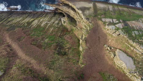Top-down-aerial-pan-reveals-cliff's-striking-pointy-side