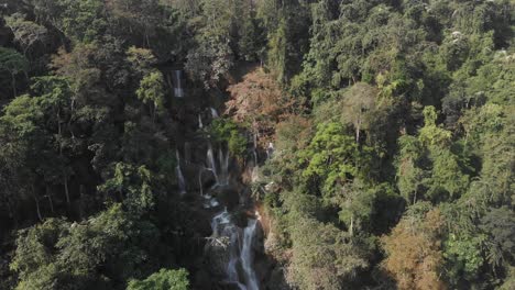 Wide-shot-of-Tat-Kuang-Si-Waterfall-in-Luang-Prabang,-Laos,-Beautiful-waterfall-in-jungle-tropical-rainforest,-aerial