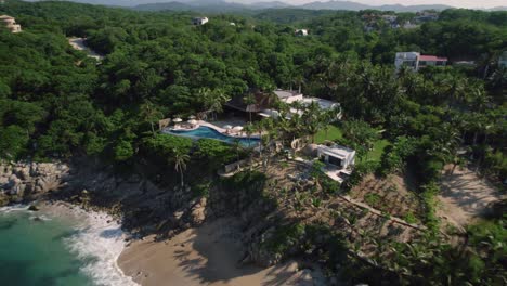 Huatulco-hotel-destination-surrounded-by-a-sandy-beach-with-sea-and-palm-jungle
