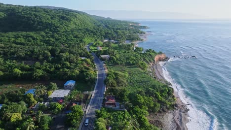 Drone-birds-eye-shot-of-tropical-road-near-Caribbean-Sea-during-sunny-day-on-Dominican-Republic-island