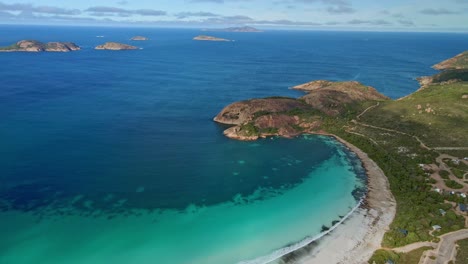 Aerial-view-over-a-campground-next-to-the-beach,-Lucky-Bay,-Esperance---Australia---orbit,-drone-shot