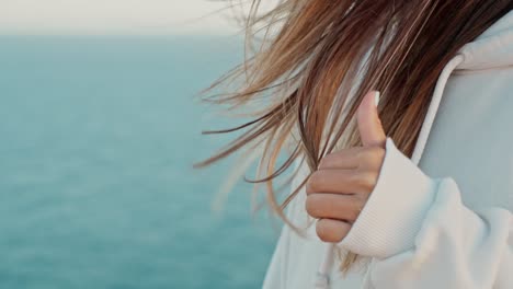 Slow-Motion-Shot-Of-Girl-Moving-Fingers-Into-Her-Beautiful-Brown-Hair-In-Front-Of-Sea