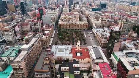Aerial-orbit-establishing-of-the-Plaza-de-Armas-of-Santiago,-center-of-the-capital-of-Chile,-morning-with-soft-light,-garden-in-the-middle-of-the-city