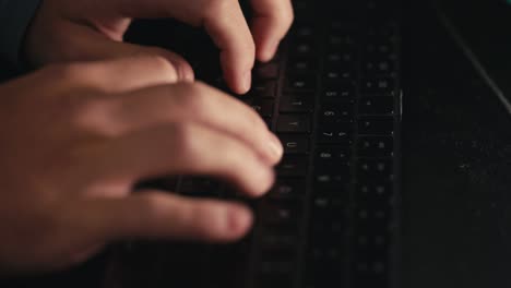 side-view-of-fingers-typing-on-a-black-keyboard