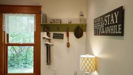 panning-shot-of-a-mud-room-with-coat-hanger-and-clever-decorations-on-the-wall