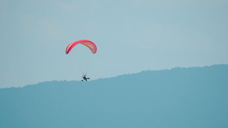 Motorized-Hang-Glider-Flying-Against-Mountains-Landscape---Tracking-Motion