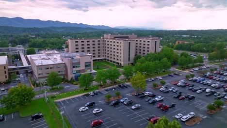 Johnson-City-Medical-Center-aerial-reveal-over-the-trees-in-Johnson-City-Tennessee