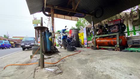 Tire-repair-shop-on-the-road-side,-Indonesia