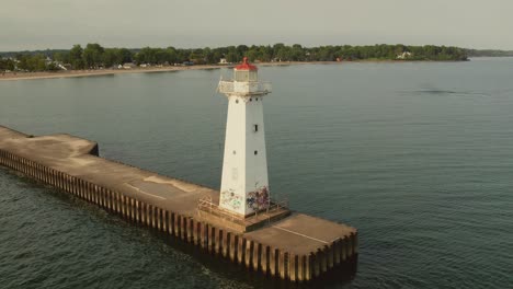 Drone-aerial-rotation-shot-of-the-light-houses-at-Sodus-point-New-York-vacation-spot-at-the-tip-of-land-on-the-banks-of-Lake-Ontario