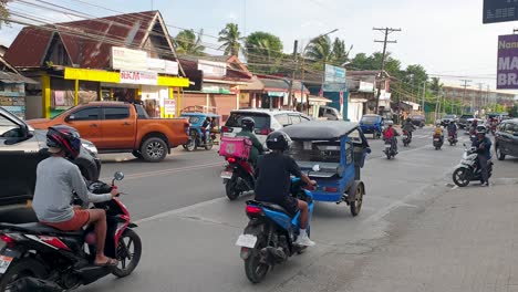 Scooters,-tricycles-and-traffic-commuting-on-the-streets-of-Puerto-Princesa-in-Palawan,-Philippines,-Southeast-Asia