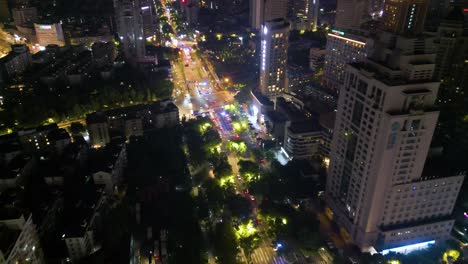 Night-time-aerial-over-Hangzhou-downtown-avenue-and-residential-area,-China
