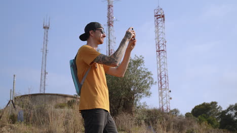young-men-on-hike-filming-with-smartphone-camera-unseen-landmark
