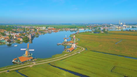 Beautiful-skyline-aerial-of-traditional-Dutch-Mills-next-to-Zaan-river-in-Holland