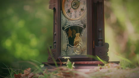 antique-wooden-pendulum-clock-in-a-forest-medium-shot-slow-motion
