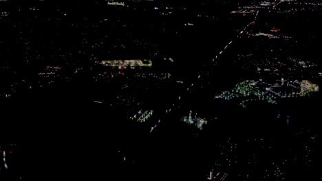 A-4K-night-low-shot-before-landing-from-a-plane-on-approach-to-Washington-International-Dulles-Airport-USA-located-in-Virginia-showing-flood-lighted-buildings-26-miles-from-Washington-DC