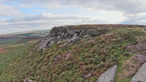 Quick-flying-aerial-fpv-soars-along-gritstone-rocky-cliffs-of-Stanage-Edge-England