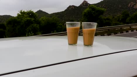 hot-tea-filled-in-glasses-at-highway-side-from-unique-perspective-at-day