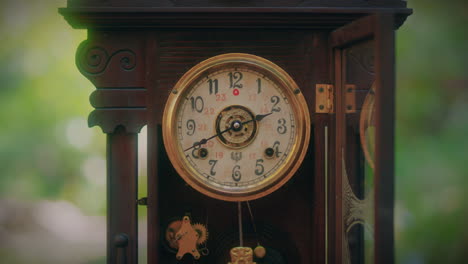 antique-wooden-pendulum-clock-in-a-forest-medium-close-shot