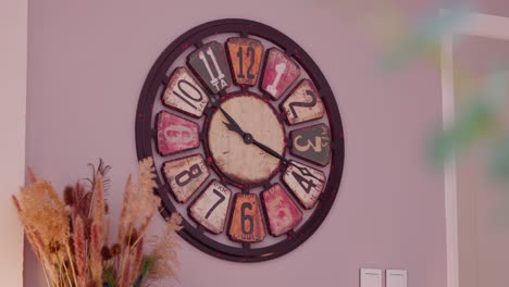 Slow-revealing-shot-of-a-large-antique-designed-wall-clock-hanging