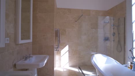 Establishing-shot-of-a-modern-bathroom-with-a-standalone-bathtub-and-shower