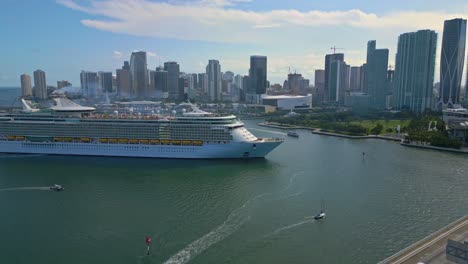 Cruise-ship-and-waterfront-of-Miami-with-iconic-buildings-and-traffic-on-the-bridge