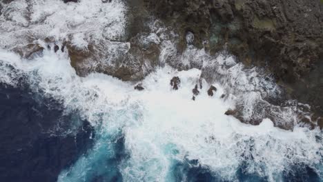 Aerial-view-of-sea-waves-crashing-on-rocks