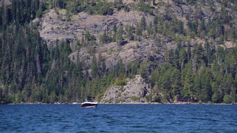 A-motorboat-in-Emerald-Bay,-Lake-Tahoe-near-Fannette-Island-and-the-rugged-shoreline