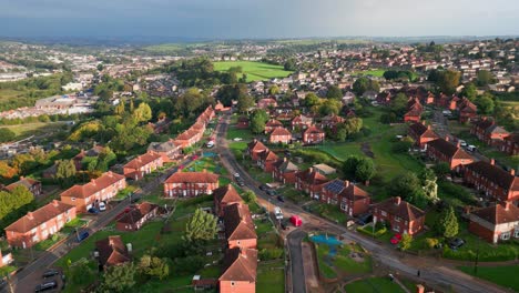 Yorkshire's-urban-charm:-Aerial-footage-showcasing-the-red-brick-council-housing,-bathed-in-the-morning-sun,-and-a-vibrant-community-in-action