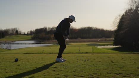 slow-motion-golf-swing-with-an-iron-from-a-male-golfer-during-golden-hour