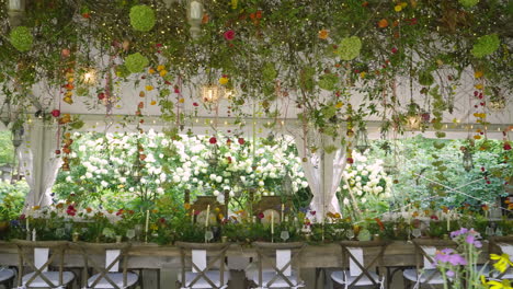 Panning-Sliding-Shot-of-Exquisite-Long-Banquet-Table-Decorated-in-Fairytale-Theme-Surrounded-by-Flowers