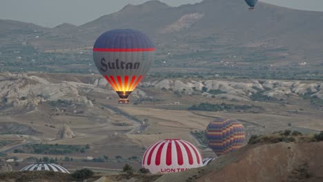 High-angle-view-of-hot-air-balloons-rising-into-sky,-Cappadocia,-Turkey
