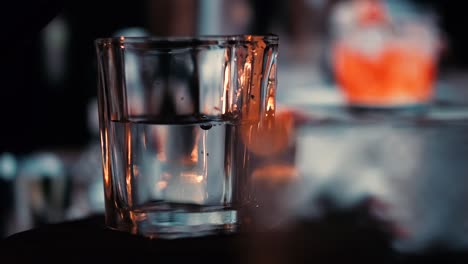 4k-epic-drink-at-bar-with-bartender-at-background-with-moody-bokeh-and-lighting