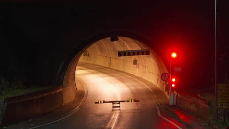 No-Entry-Barrier-And-Red-Traffic-Lights-Flashing-At-The-Entrance-Of-Road-Tunnel-At-Night-In-Norway