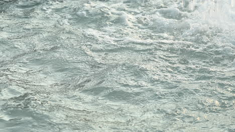 Closeup-shot-of-gushing-water-splashing-in-the-fountain,-shot-at-120-fps-in-4k
