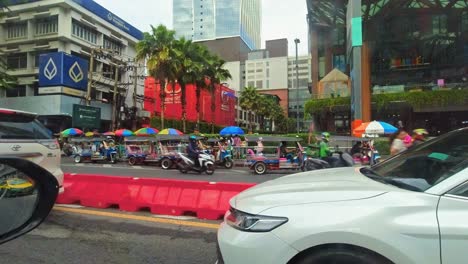 Driver's-Eye-View-of-Downtown-Traffic,-Featuring-Tuk-Tuk-Taxis-Waiting-for-Tourists