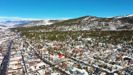 Breckenridge-Colorado-Aerial-Drone-Reveal-of-City-with-Houses-and-Hotels-Covered-in-Winter-Snow