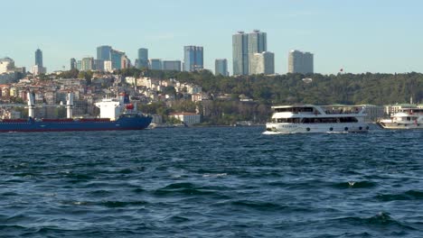 Boats-Passing-The-Bosphorus-Strait,-Cityscape-In-The-Background,-Istanbul,-Turkey