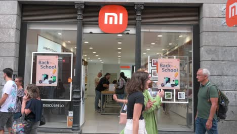 Customers-shop-at-the-Chinese-multinational-technology-and-electronics-brand-Xiaomi-flagship-store-as-pedestrians-walk-across-the-frame