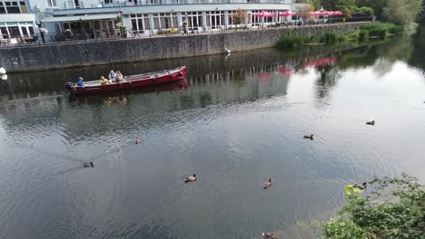 Kilkenny-City-tourist-boat-sailing-down-the-Nore-River-on-a-calm-Sunday-Morning-in-Summer