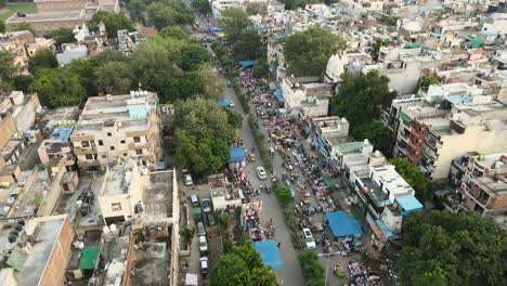 4K-Aerial-Shots-of-a-Local-market-in-New-Delhi-Residential-Suburbs-on-a-beautiful-day-gliding-over-Rooftops,-streets,-parks-and-markets-in-India