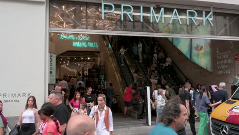 Pedestrians-and-shoppers-are-seen-in-front-of-the-Irish-fashion-retailer-brand-Primark-store-main-entrance-in-Spain