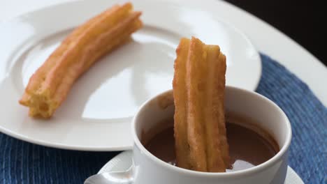 Spanish-snack-fried-dough-known-as-Churros-being-dipped-in-hot-chocolate-sauce