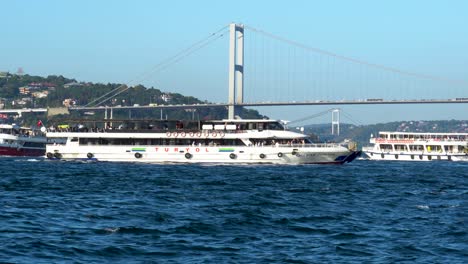 Ferry-Traffic-On-Bosphorus-Strait-With-Two-Bridges-In-The-Background,-Istanbul,-Turkey