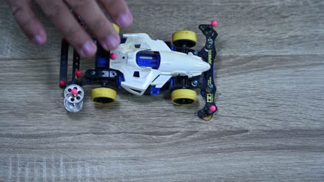 A-white-rocket-racer-tested-of-its-balance-before-race,-Tamiya-Mini-4X4