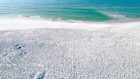 fly-over-the-walking-path-on-the-white-sand-beach-of-Pensacola-Beach-to-the-clear-emerald-waters-of-the-Gulf-of-Mexico-on-a-clear-sunny-day