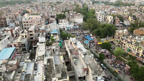 4K-Aerial-Shots-of-Local-market-in-New-Delhi-Residential-Suburbs-on-a-beautiful-day-gliding-over-Rooftops,-streets,-parks-and-markets-in-India