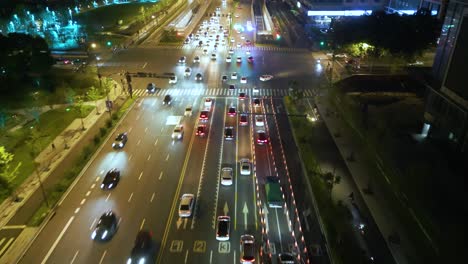 Aerial-view-following-street-traffic-in-night-time-at-Hangzhou,-Zhejiang-Province,-China