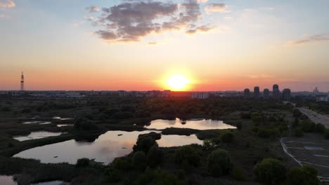 Aerial-View-Over-Vacaresti-Delta-At-Sunset,-Orange,-Yellow,-Bucharest,-Romania